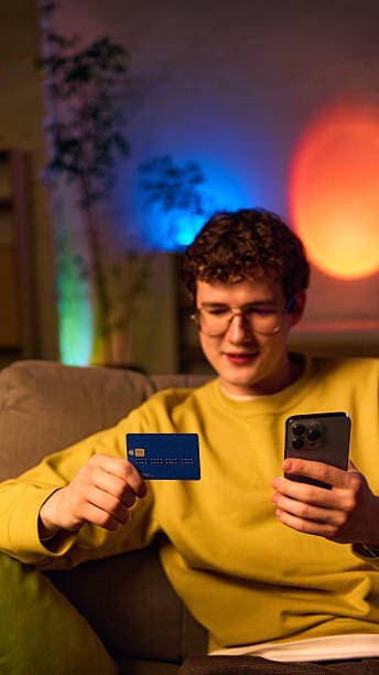 Person checking out on a smartphone with a payment card