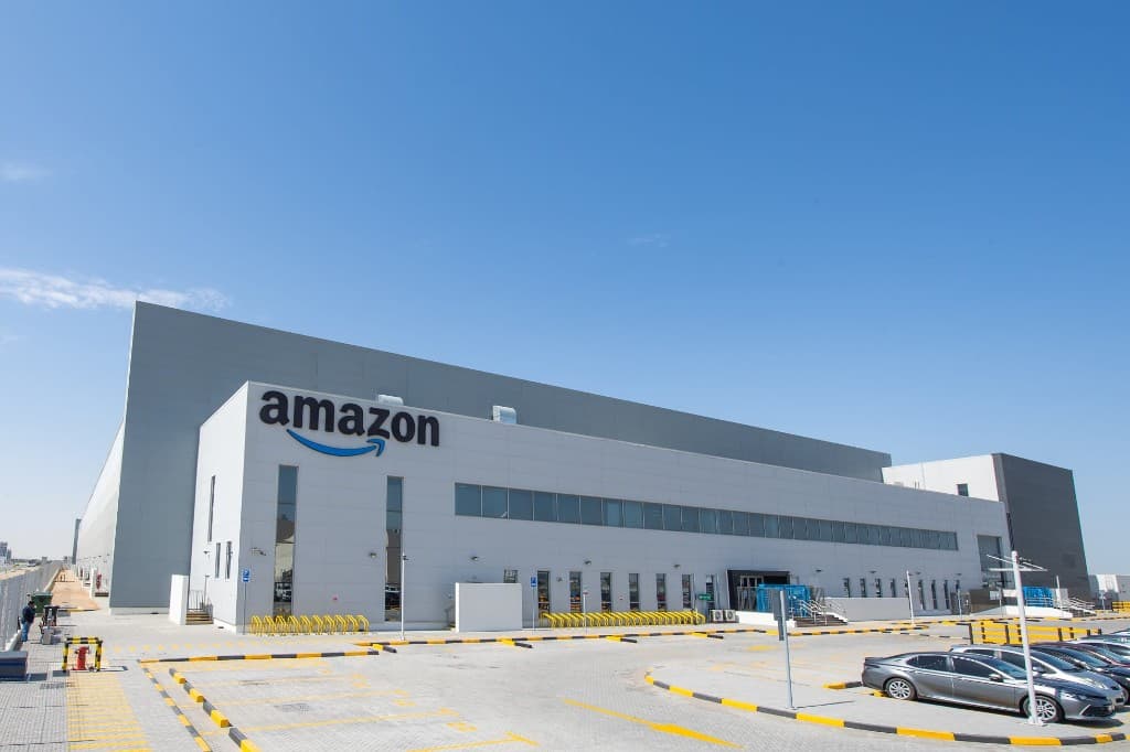 Exterior of an Amazon fulfillment center under a clear blue sky